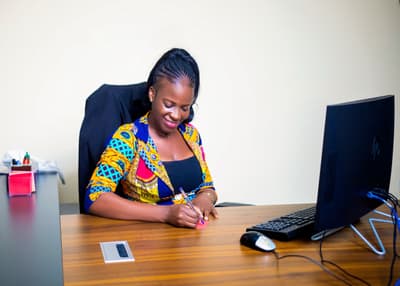 An LCS team member writing at a desk