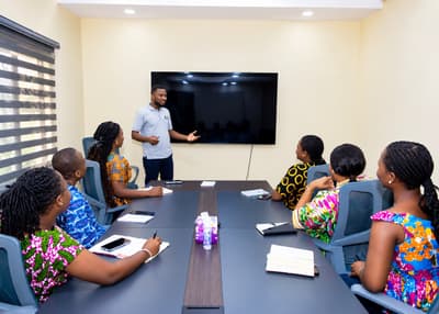 An LCS team member presenting to colleagues in the boardroom